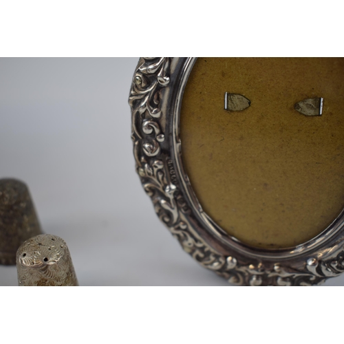 214 - Antique silver photo frames together with two silver thimbles (4).