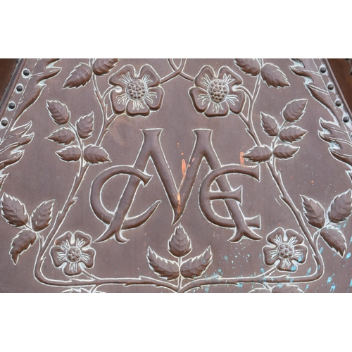 288 - In the manner of John Pearson: an early 20th century embossed copper fire surround / chimney with fl... 