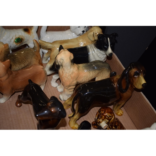 124 - A quantity of ceramic dog figures by Staffordshire potteries, dog breeds include Collie, Doberman, W... 