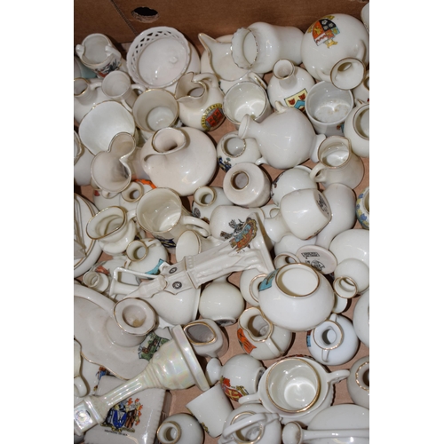 127 - A collection of crested china items to include animals, jugs, vases and varying forms and decoration... 