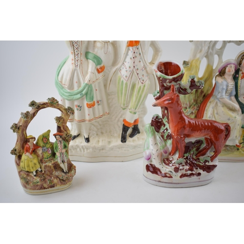 129 - A collection of Staffordshire flatback figures to include a fox with romantical scenes (Qty)