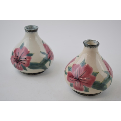 13 - A pair of Cobridge Stoneware pottery vases with pink floral design, 10cm tall (2).