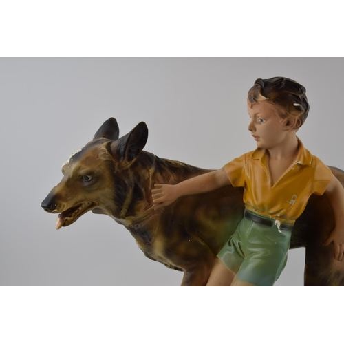 146 - Mid century chalk ware figure of a boy with Alsatian / German Shepherd dog.