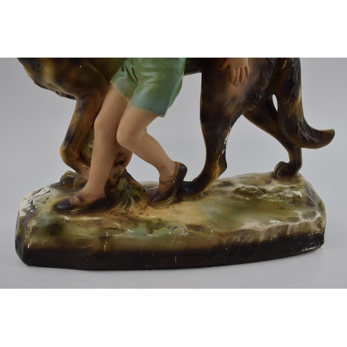 146 - Mid century chalk ware figure of a boy with Alsatian / German Shepherd dog.