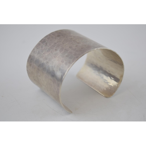 175 - Sterling silver hammered wide bangle, 65.2 grams, 52mm wide, London 2011, M C Hersey & Son Ltd (Stew... 