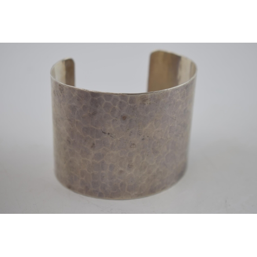 175 - Sterling silver hammered wide bangle, 65.2 grams, 52mm wide, London 2011, M C Hersey & Son Ltd (Stew... 