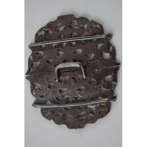 218 - Hallmarked silver belt buckle with ornate decoration, 33.2 grams.