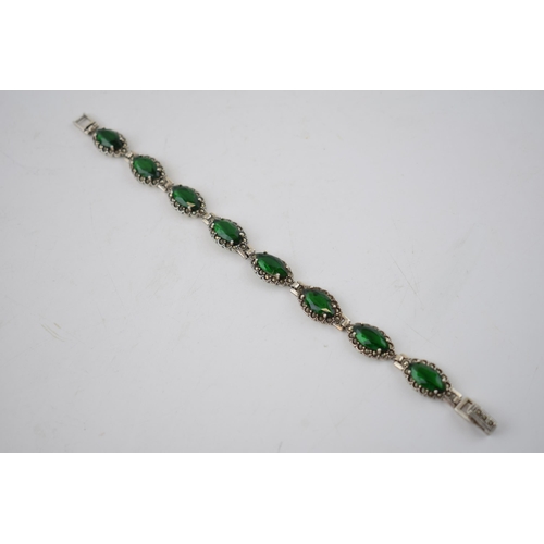 220 - Sterling silver bracelet set with green stones, 18.5 grams, 20cm long.