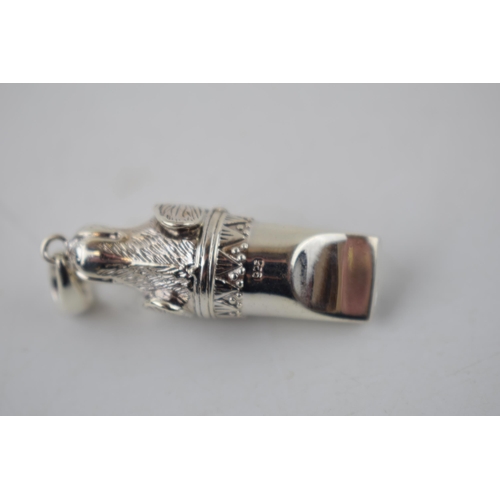 230 - Sterling silver whistle in the form of a dog's head, 5cm long.