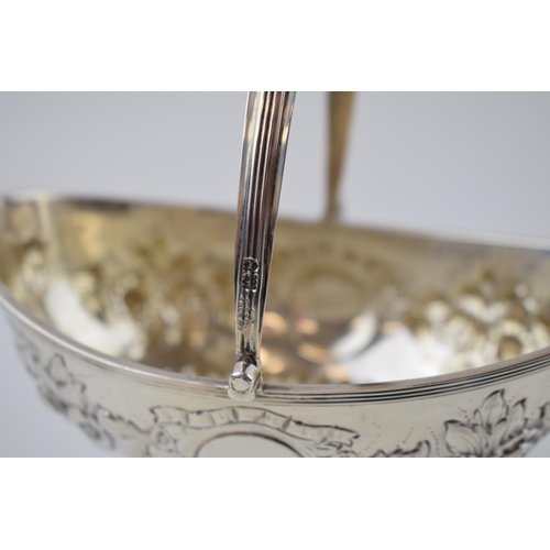 245 - Hallmarked silver basket with swingover handle and repousse decoration, 180.1 grams, London 1907, 15... 