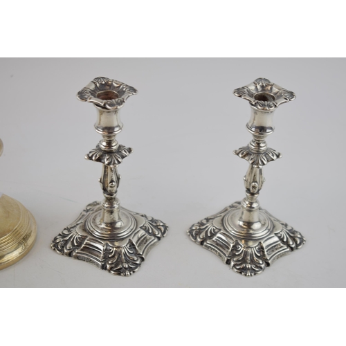 249 - A pair of Walker and Hall silver ornate candlesticks, Sheffield 1900, loaded, gross weight 240 grams... 