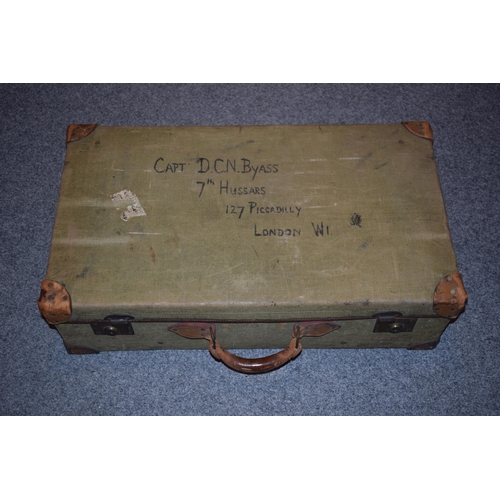 258 - A vintage green canvas trunk with leather handle with name CAPT. D.C.N Byass 7th Hussars, 127 Piccad... 