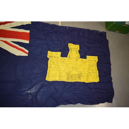 270 - A panel stitched flag with castle motif. 214cm x 95cm.