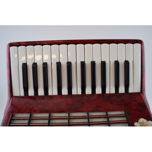 273 - Cased Worldmaster Accordion decorated with red lacquer in working order.