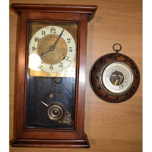 279 - A wall clock with ceramic dial and pendulum movement together with a barometer. (2)