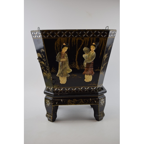 310 - Oriental black lacquered planter on stand with applied figural scenes. Wooden base with tin liner. H... 