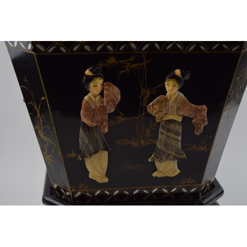 310 - Oriental black lacquered planter on stand with applied figural scenes. Wooden base with tin liner. H... 