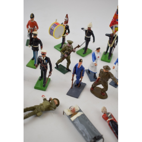 369 - A collection of Britains and similar lead military figures including soldiers, nurses and flag beare... 