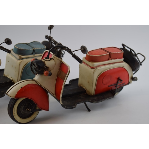 399 - A pair of vintage style models of 2 lambrettas, one in blue and the other in red, 41cm long (2).