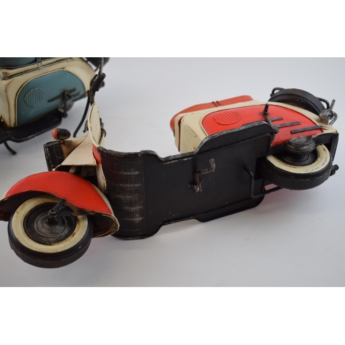 399 - A pair of vintage style models of 2 lambrettas, one in blue and the other in red, 41cm long (2).