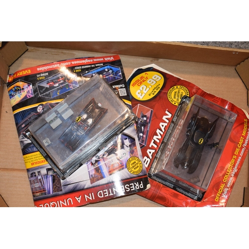 401 - A mixed collection of boxed Batman figures and two Batmobile cars together with Disney Showcase coll... 