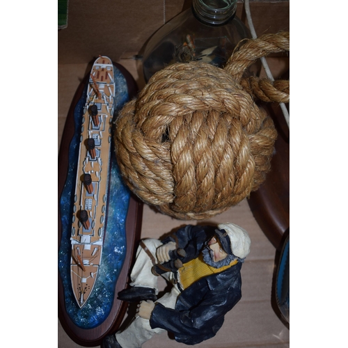 269A - Nautical themed items to include a resin model of the Titanic, a boat lamp base, a sailor figure and... 