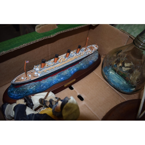 269A - Nautical themed items to include a resin model of the Titanic, a boat lamp base, a sailor figure and... 