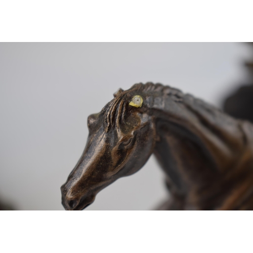 279A - A trio of bronze effect resin figures to include Genesis Fine Arts and a figure of a horse (ears af)... 