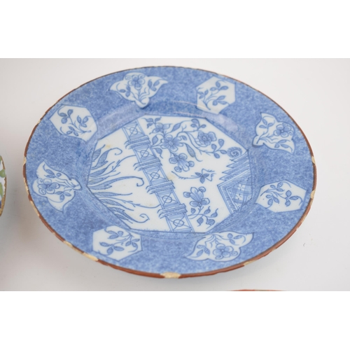 138 - A Delft tin glazed earthenware plate, mid 18th century, decorated with a central fence pattern with ... 