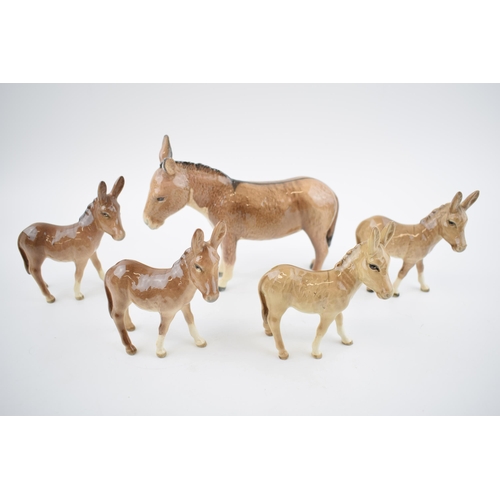 74 - A collection of Beswick Donkeys to include a large donkey with 4 foals (5).