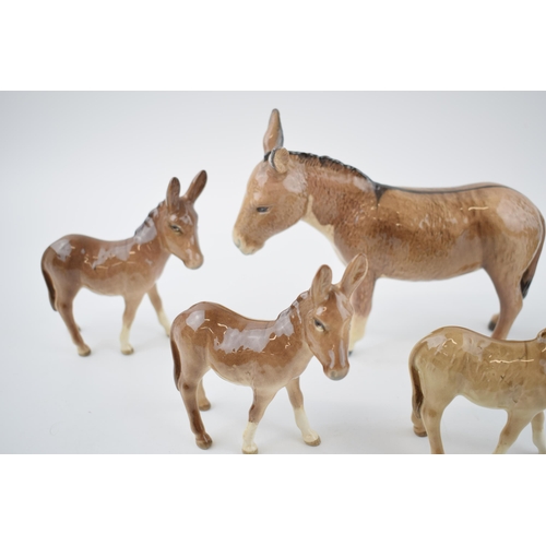 74 - A collection of Beswick Donkeys to include a large donkey with 4 foals (5).