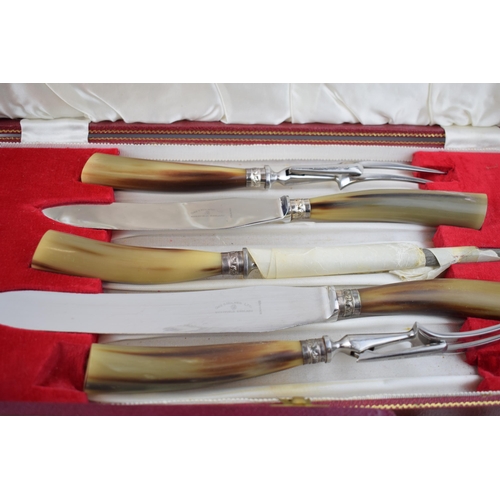 385 - A set of cased horn handled carving knives by Gee Holmes Ltd, Sheffield together with a set of cased... 