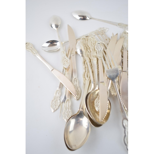 393 - A good collection of silver 830 cutlery with an ornate filigree design, hallmarked 830 with others, ... 