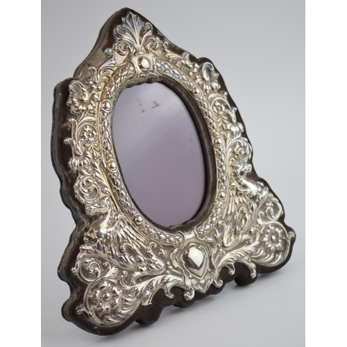 396 - Hallmarked silver ornate photo frame with easel-back, with oval insert, 22.5cm tall, indistinct hall... 