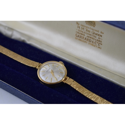 405 - 9ct gold ladies Garrard wristwatch on 9ct gold strap, cased, gross weight 15.9 grams, in working ord... 