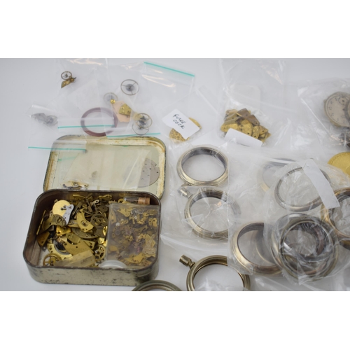 412 - A large quantity of pocket watch parts including movements, cases, crowns, and stems. Of note severa... 