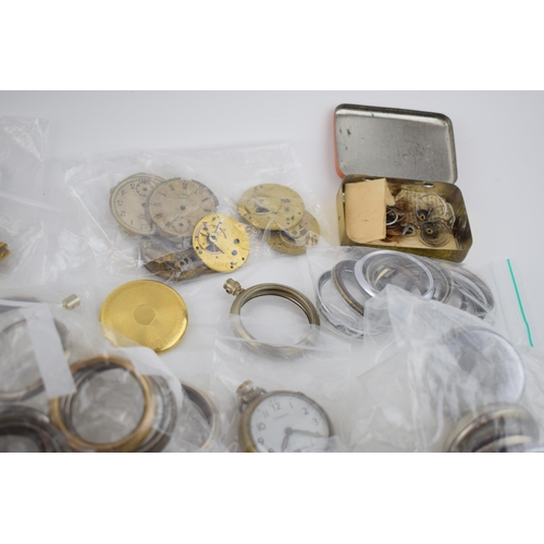 412 - A large quantity of pocket watch parts including movements, cases, crowns, and stems. Of note severa... 