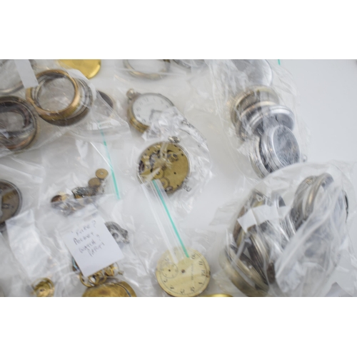 412 - A large quantity of pocket watch parts including movements, cases, crowns, and stems. Of note severa... 