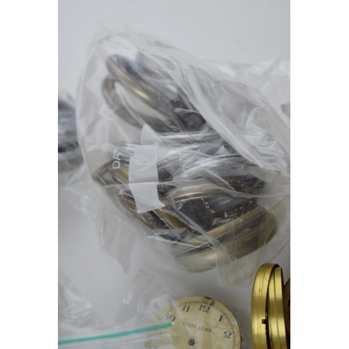 412 - A large quantity of pocket watch parts including movements, cases, crowns, and stems. Of note severa... 