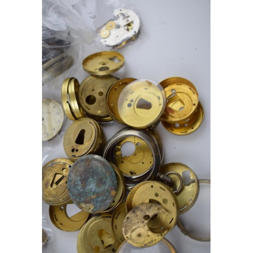 412 - A large quantity of pocket watch parts including movements, cases, crowns, and stems. Of note severa... 