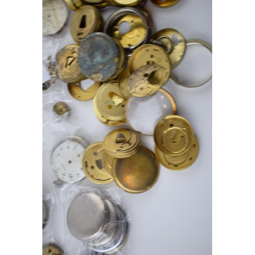 412 - A large quantity of pocket watch parts including movements, cases, crowns, and stems. Of note severa... 