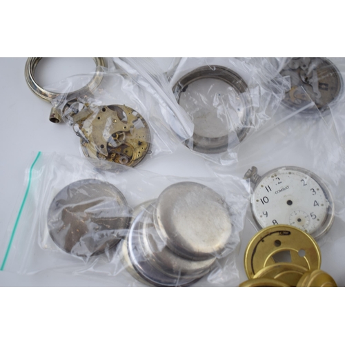 412 - A large quantity of pocket watch parts including movements, cases, crowns, and stems. Of note severa... 