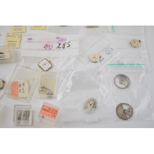 421 - A collection of Longines watch movements and parts. To include rotors, stems, with some NOS parts no... 