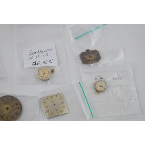 421 - A collection of Longines watch movements and parts. To include rotors, stems, with some NOS parts no... 