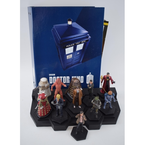 655 - A collection of Doctor Who figures by DW (TM BBC) together with display stand and accompanying magaz... 