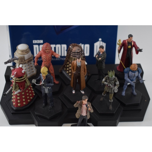 655 - A collection of Doctor Who figures by DW (TM BBC) together with display stand and accompanying magaz... 