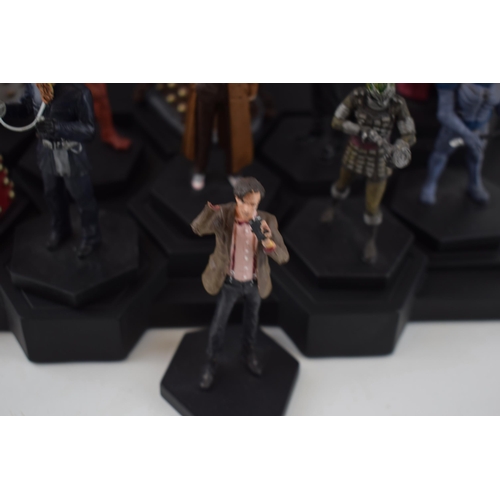 655 - A collection of Doctor Who figures by DW (TM BBC) together with display stand and accompanying magaz... 