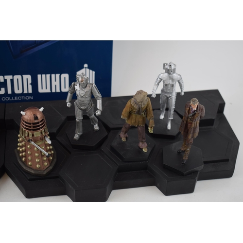 656 - A collection of Doctor Who figures by DW (TM BBC) together with display stand and accompanying magaz... 