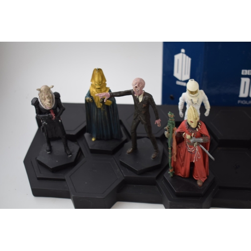 656 - A collection of Doctor Who figures by DW (TM BBC) together with display stand and accompanying magaz... 