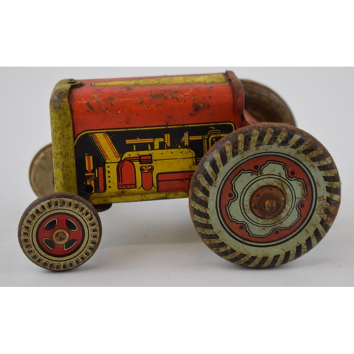 663 - Mettoy tinplate model of a tractor, with blue wheels and a red body, with a vintage tin plate 'Rainb... 